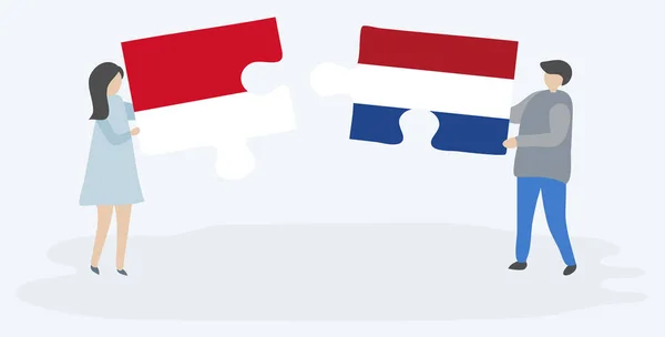 Para Trzymania Dwóch Puzzli Indonezyjskich Niderlandzkich Flag Symbole Narodowe Indonezji — Wektor stockowy