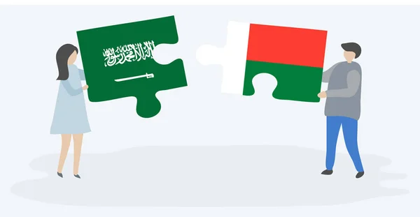 Casal Segurando Duas Peças Quebra Cabeças Com Bandeiras Sauditas Malgaxes — Vetor de Stock