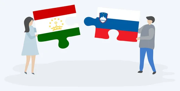 Dvojice Tádžické Slovinským Prapory Drží Dvě Skládanky Národní Symboly Tádžikistánu — Stockový vektor