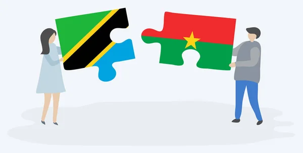 Couple Holding Two Puzzles Pieces Tanzanian Burkinabe Flags Tanzania Burkina — Stock Vector