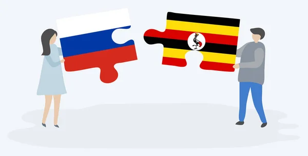 一对夫妇拿着两块拼图 上面挂着俄罗斯和乌干达国旗 俄罗斯和乌干达国家符号在一起 — 图库矢量图片