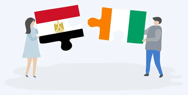 Ζευγάρι Που Κατέχει Δύο Κομμάτια Παζλ Αιγυπτιακές Και Τις Σημαίες — Διανυσματικό Αρχείο