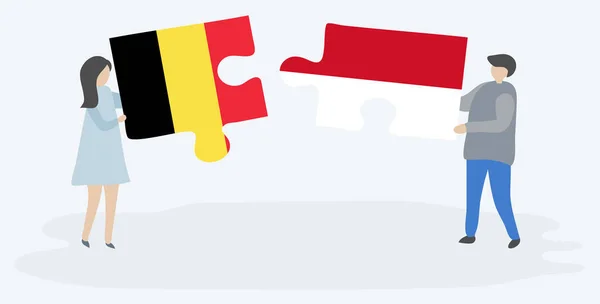 Para Trzyma Dwa Kawałki Puzzli Belgijskich Indonezyjskich Flag Symbole Narodowe — Wektor stockowy
