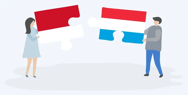 Пара Держащая Две Головоломки Индонезийскими Люксембургскими Флагами Индонезия Люксембург Вместе — стоковый вектор