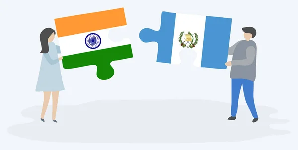 インドとグアテマラの旗を持つ2つのパズルのピースを保持しているカップル インドとグアテマラの国のシンボル — ストックベクタ