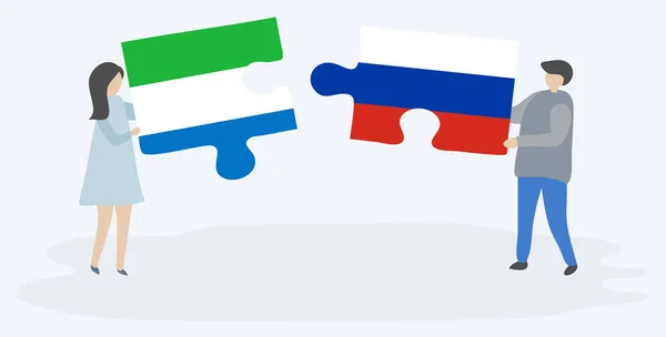 Pareja Sosteniendo Dos Piezas Rompecabezas Con Banderas Sierra Leona Rusia — Vector de stock