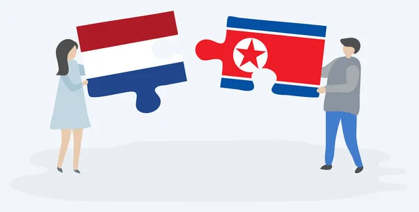 Paar Mit Zwei Puzzleteilen Mit Holländischen Und Nordkoreanischen Flaggen Niederländische — Stockvektor