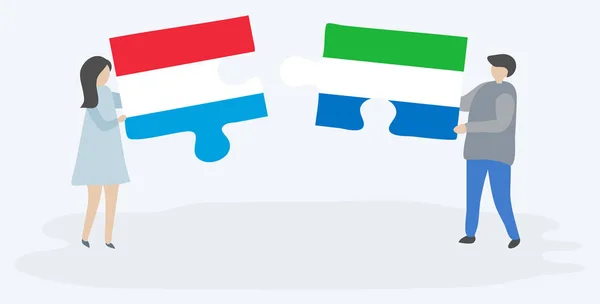 Paar Houden Twee Puzzels Stukken Met Luxemburgse Sierra Leonean Vlaggen — Stockvector