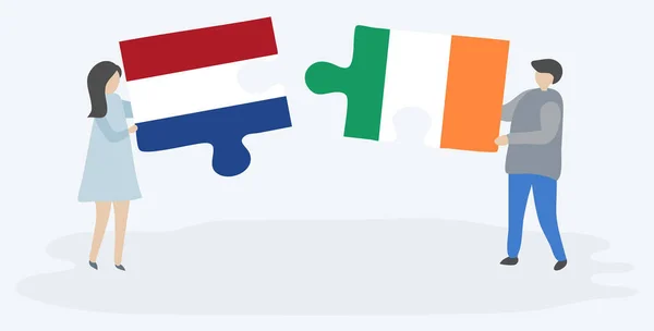 Couple Tenant Deux Pièces Puzzles Avec Des Drapeaux Néerlandais Irlandais — Image vectorielle