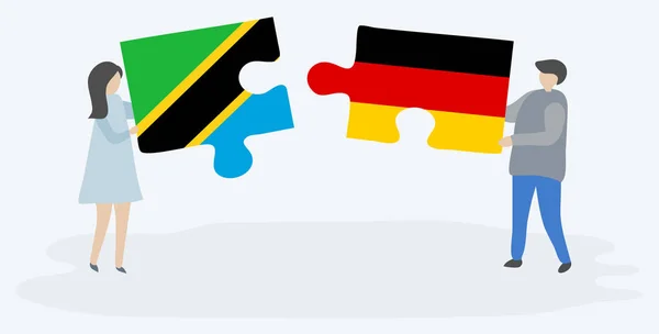 Pareja Sosteniendo Dos Piezas Rompecabezas Con Banderas Tanzania Alemania Tanzania — Vector de stock