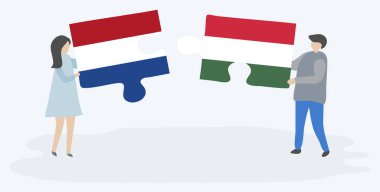 Hollanda ve Macar bayrakları ile iki bulmaca parçaları tutan çift. Hollanda ve Macaristan ulusal sembolleri birlikte.