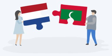 Hollanda ve Maldiv bayrakları ile iki bulmaca parçaları tutan çift. Hollanda ve Maldivler ulusal semboller birlikte.