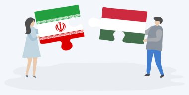 İran ve Macar bayrakları ile iki bulmaca parçaları tutan çift. İran ve Macaristan ulusal sembolleri bir arada.