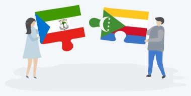 Çift Ekvator Ginesi ve Comoran bayrakları ile iki bulmaca parçaları tutan. Ekvator Ginesi ve Komorlar ulusal sembolleri birlikte.