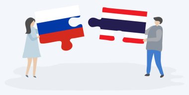 Rus ve Tay bayrakları ile iki bulmaca parçaları tutan çift. Rusya ve Tayland ulusal sembolleri birlikte.