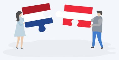 Hollanda ve Avusturya bayrakları ile iki bulmaca parçaları tutan çift. Hollanda ve Avusturya ulusal sembolleri birlikte.