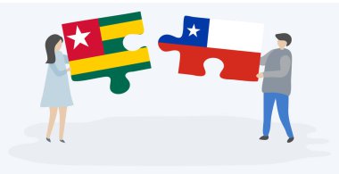Togolya ve Şili bayraklarıyla iki bulmaca tutan çift. Togo ve Şili ulusal sembolleri birlikte.