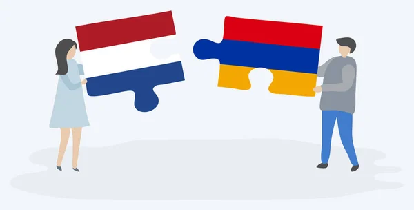 Para Trzymania Dwóch Puzzli Holenderskich Ormiańskich Flag Symbole Narodowe Holandii — Wektor stockowy