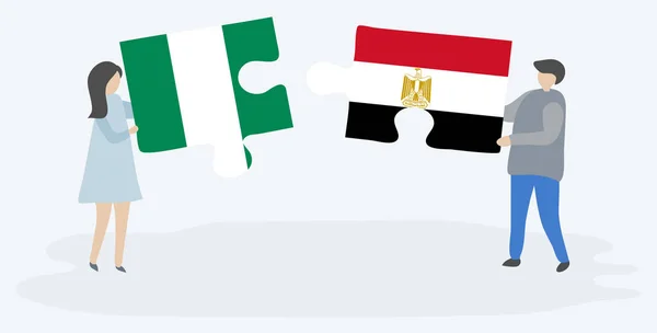 Pár Jich Drží Dvě Skládanky Nigerijskými Egyptskými Vlajkami Nigérie Egypt — Stockový vektor
