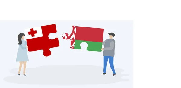 一对夫妇拿着两个拼图 上面挂着汤加和白俄罗斯国旗 汤加和白俄罗斯国家符号在一起 — 图库矢量图片