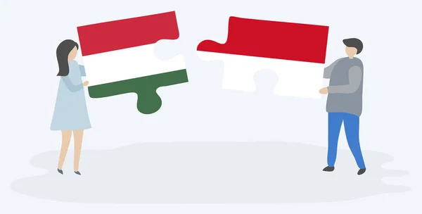 一对夫妇拿着两个拼图片与匈牙利和摩纳哥国旗 匈牙利和摩纳哥国家符号在一起 — 图库矢量图片