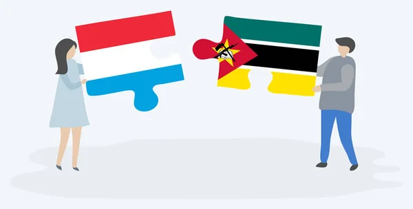 Couple Tenant Deux Pièces Puzzles Avec Drapeaux Luxembourgeois Mozambicains Symboles — Image vectorielle