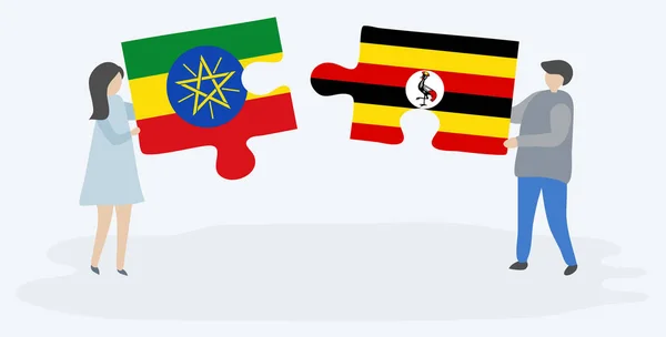 Para Trzymania Dwóch Puzzli Etiopii Ugandy Flagi Etiopia Uganda Symbole — Wektor stockowy