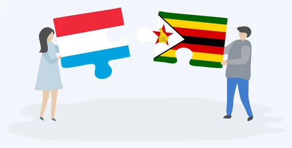 Çift Lüksemburg Zimbabve Bayrakları Ile Iki Bulmaca Parçaları Tutan Lüksemburg — Stok Vektör