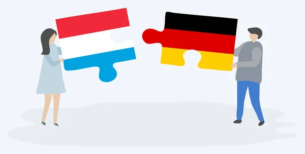 Pareja Sosteniendo Dos Piezas Rompecabezas Con Banderas Luxemburguesas Alemanas Luxemburgo — Vector de stock