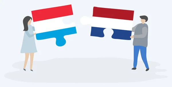 一对夫妇拿着两块拼图 上面挂着卢森堡和荷兰国旗 卢森堡和荷兰国家符号在一起 — 图库矢量图片