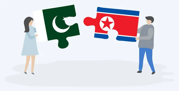 一对夫妇拿着两块拼图 上面挂着巴基斯坦和朝鲜国旗 巴基斯坦和朝鲜国家象征在一起 — 图库矢量图片