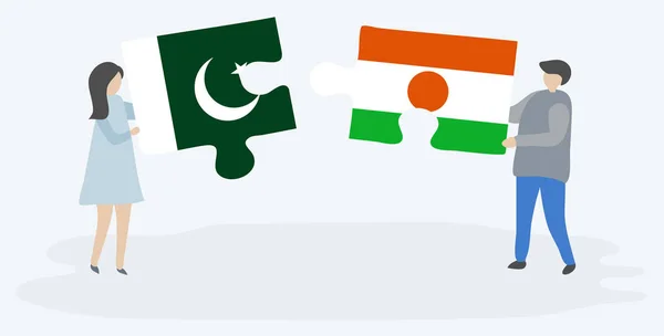 Para Trzyma Dwa Kawałki Puzzli Pakistanu Nigerien Flagi Symbole Narodowe — Wektor stockowy