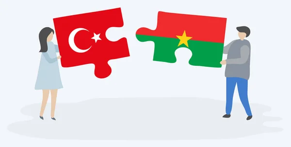 Türk Burkinabe Bayrakları Ile Iki Bulmaca Parçaları Tutan Çift Türkiye — Stok Vektör