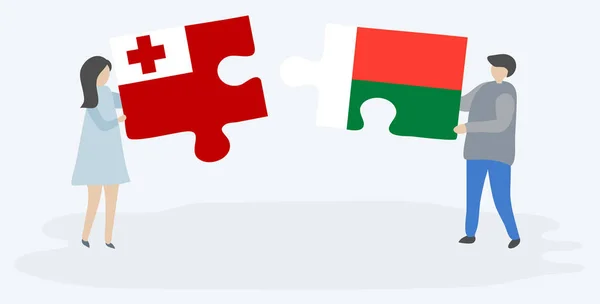 Çift Tongan Malagasy Bayrakları Ile Iki Bulmaca Parçaları Tutan Tonga — Stok Vektör