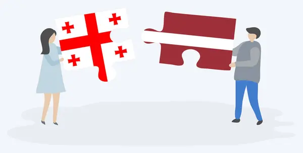 Para Trzymania Dwóch Puzzli Gruzińskich Łotewskich Flag Gruzja Łotwa Symbole — Wektor stockowy