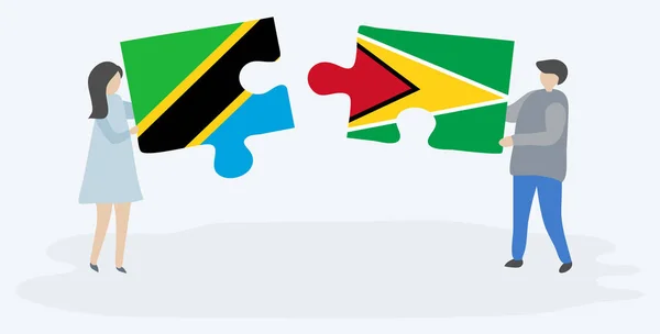 タンザニアとガイアナの旗を持つ2つのパズルピースを保持しているカップル タンザニアとガイアナの国のシンボルが一緒に — ストックベクタ