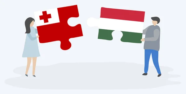 一对夫妇拿着两个拼图 上面挂着汤加和匈牙利国旗 汤加和匈牙利国家符号在一起 — 图库矢量图片