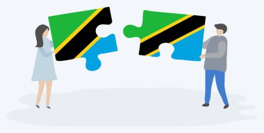 Tanzanya ve Tanzanya bayrakları ile iki bulmaca parçaları tutan çift. Tanzanya ve Tanzanya ulusal sembolleri birlikte.