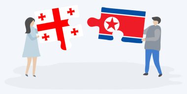 Gürcü ve Kuzey Kore bayrakları ile iki bulmaca parçaları tutan çift. Gürcistan ve Kuzey Kore ulusal sembolleri birlikte.