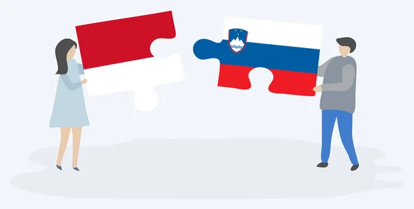 一对夫妇拿着两个拼图 上面挂着印度尼西亚和斯洛文尼亚国旗 印度尼西亚和斯洛文尼亚国家符号在一起 — 图库矢量图片