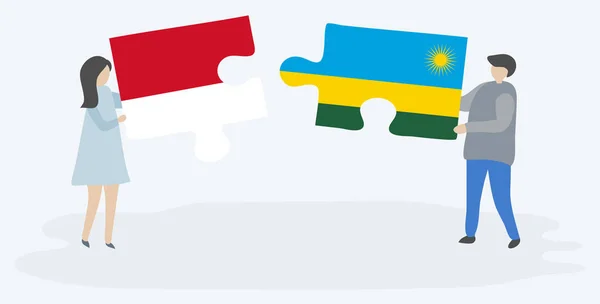 一对夫妇拿着两块拼图 上面挂着印度尼西亚和卢旺达国旗 印度尼西亚和卢旺达国家符号在一起 — 图库矢量图片