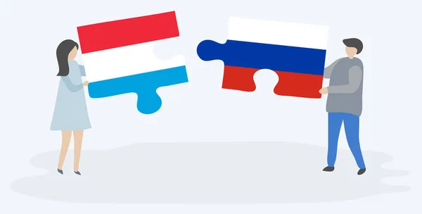 一对夫妇拿着两块拼图 上面挂着卢森堡和俄罗斯国旗 卢森堡和俄罗斯的国家符号在一起 — 图库矢量图片