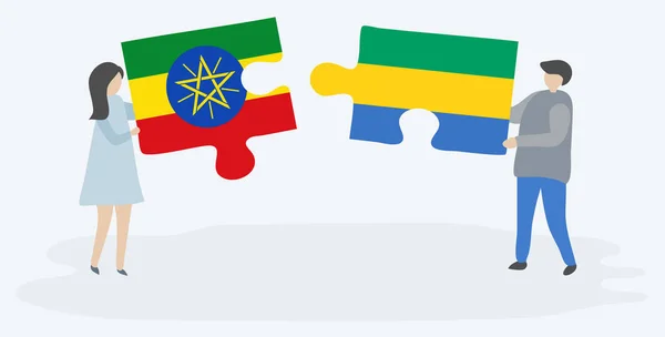 Casal Segurando Duas Peças Quebra Cabeças Com Bandeiras Etíopes Gaboneses — Vetor de Stock