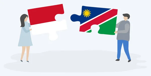 Pareja Sosteniendo Dos Piezas Rompecabezas Con Banderas Indonesia Namibia Indonesia — Vector de stock