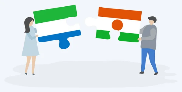 シエラレオネとナイジェリアの旗を持つ2つのパズルピースを保持しているカップル シエラレオネとニジェールのシンボル — ストックベクタ