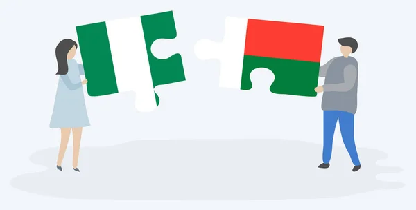 Paar Houden Twee Puzzels Stukken Met Nigeriaanse Malagasi Vlaggen Nigeria — Stockvector