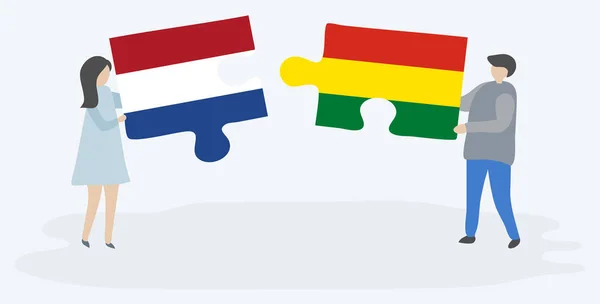 Hollanda Bolivya Bayrakları Ile Iki Bulmaca Parçaları Tutan Çift Hollanda — Stok Vektör