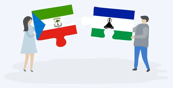 一对夫妇拿着两块拼图 上面挂着赤道几内亚和巴索托国旗 赤道几内亚和莱索托国家符号在一起 — 图库矢量图片