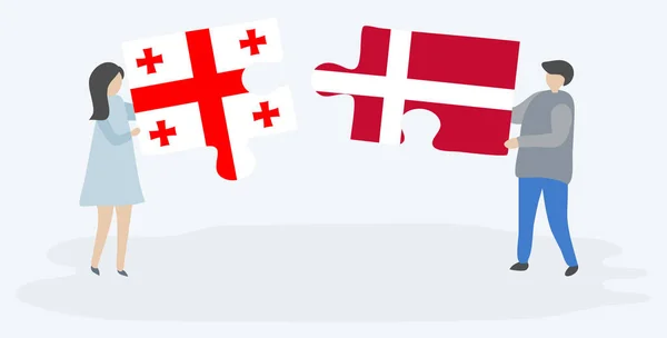 Pareja Sosteniendo Dos Piezas Rompecabezas Con Banderas Georgia Dinamarca Georgia — Archivo Imágenes Vectoriales