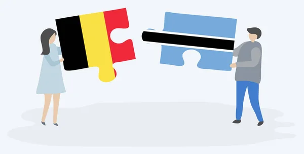 Para Trzyma Dwa Kawałki Puzzli Belgijskich Motswana Flagi Symbole Narodowe — Wektor stockowy